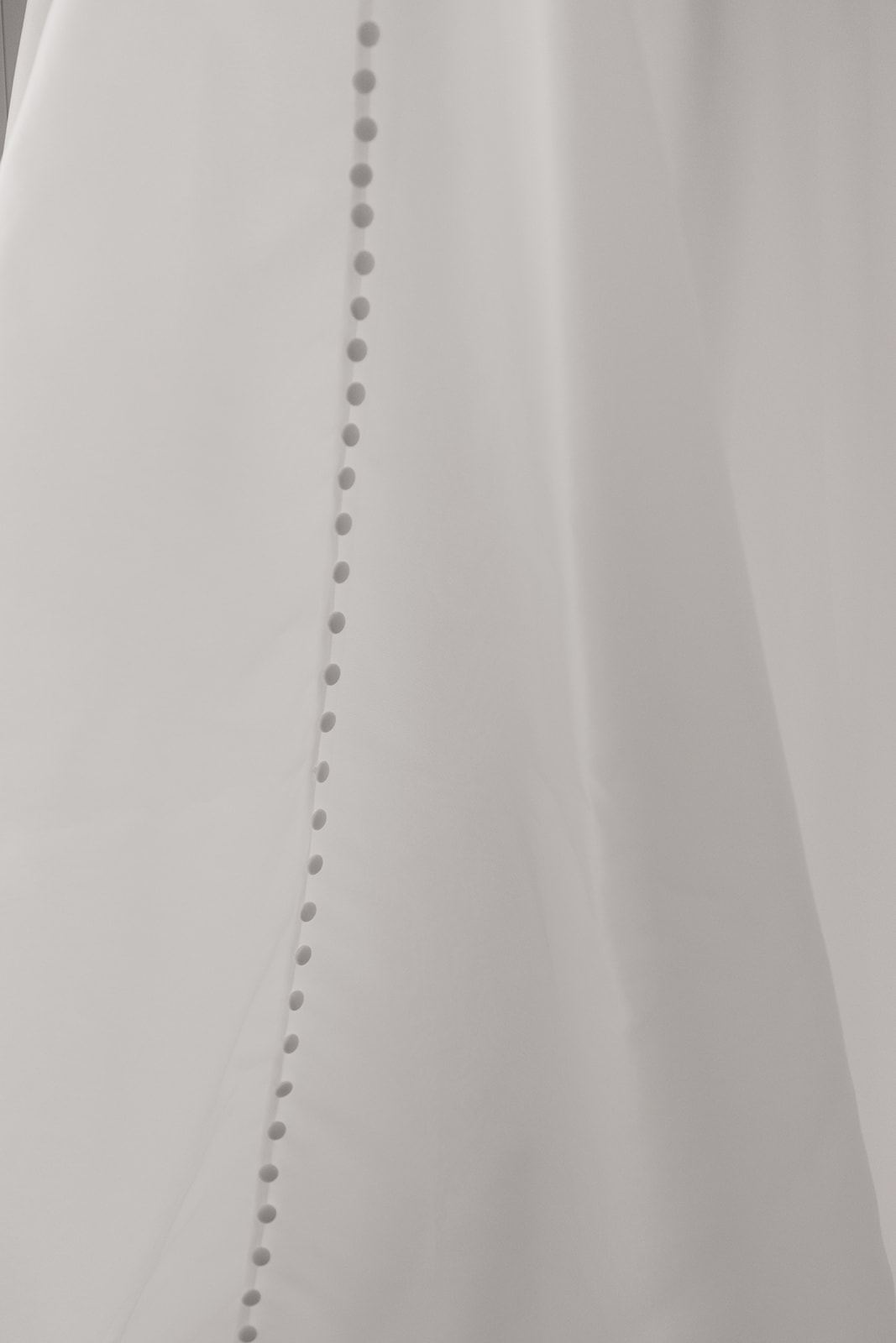 Row of covered buttons down the back of a satin gown
