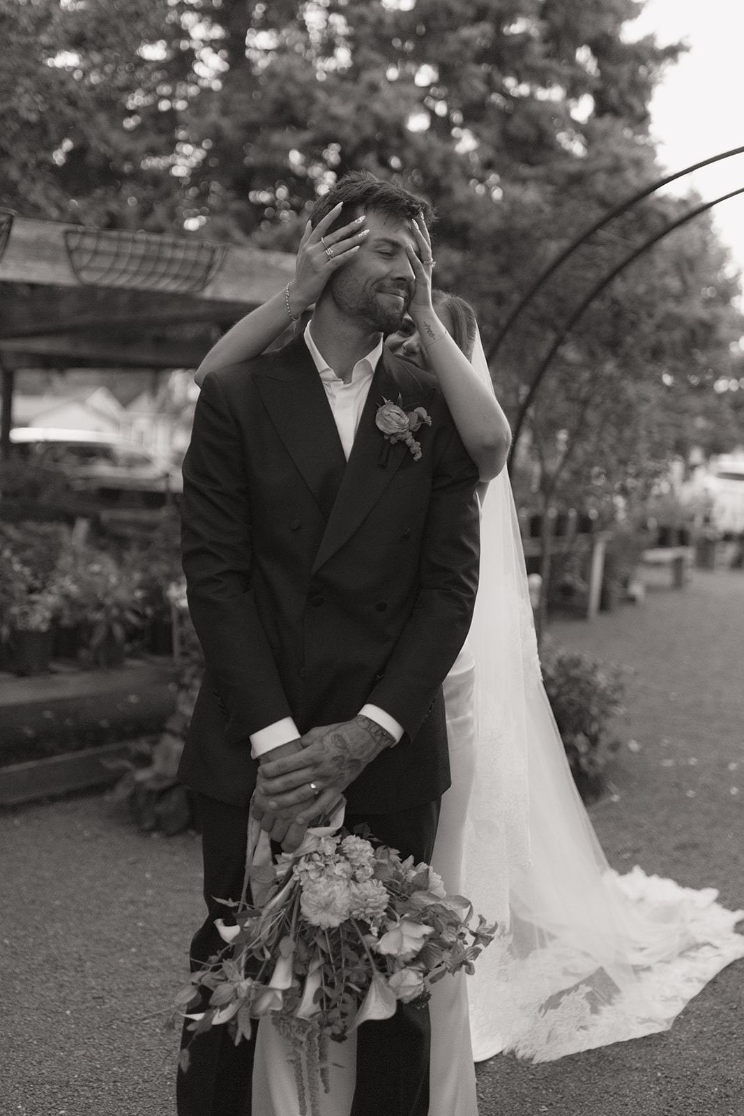 Bride covering the groom's eyes from behind for their first look